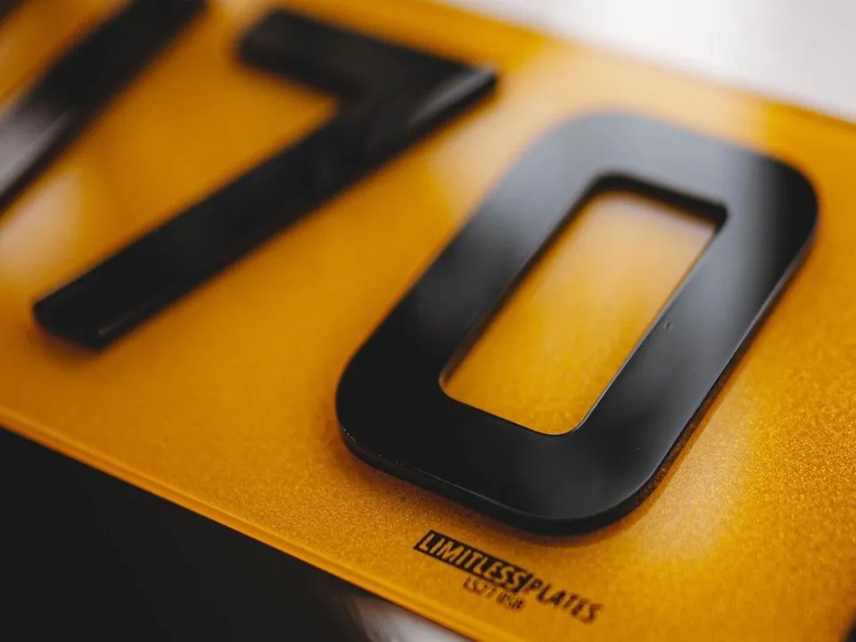 Close-up of laser-cut 4D acrylic number plate characters