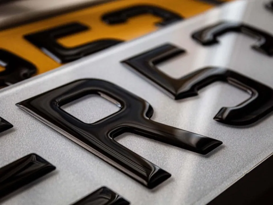 Close-up of domed 3D gel number plate characters